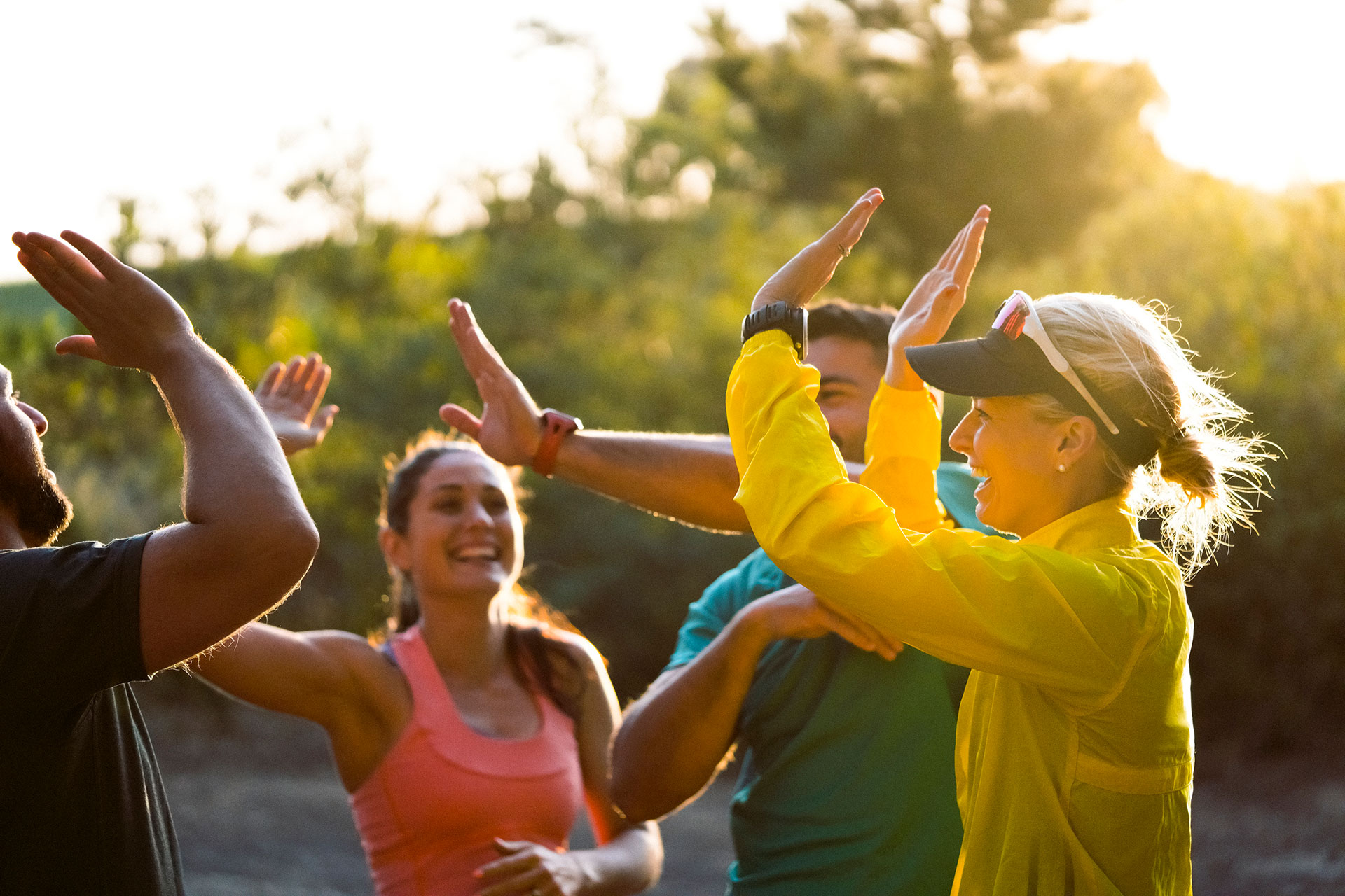 group of active individuals high-fiving